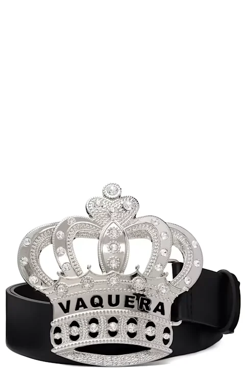 Silver crown-shaped belt buckle with rhinestones and “VAQUERA” lettering on a black leather belt against a white background