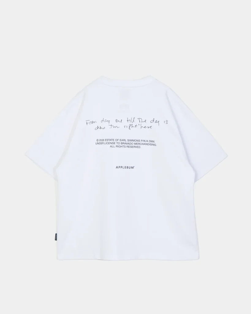White APPLEBUM T-shirt laid flat, featuring handwritten-style black text and copyright details on the chest
