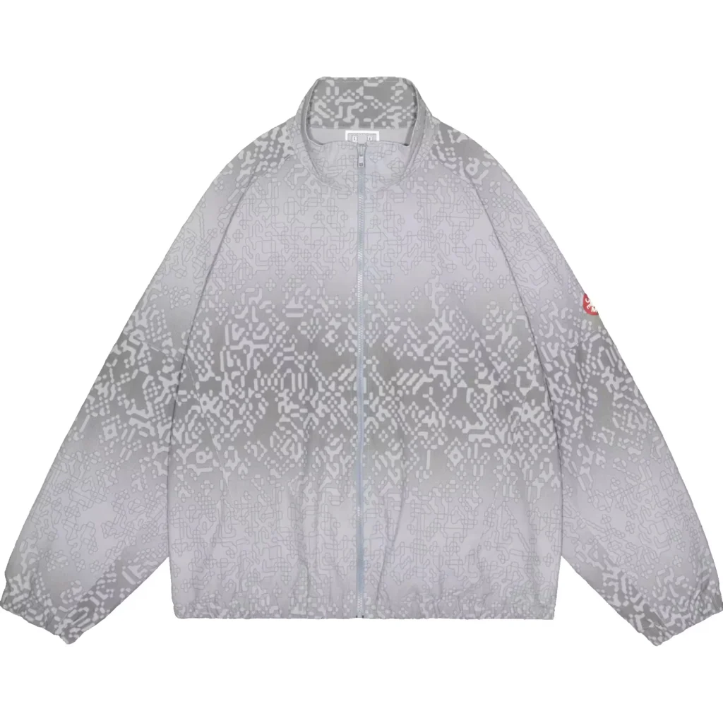 Gray zip-front jacket with an all-over pixelated pattern, stand collar, long sleeves, and red sleeve patch on white