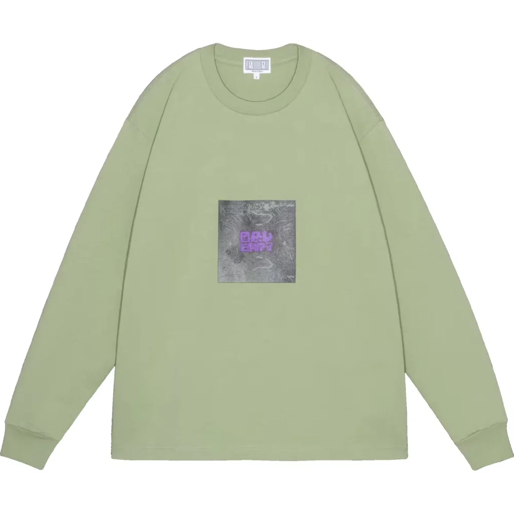 Light green long-sleeve shirt with ribbed collar and cuffs, featuring a gray square chest graphic with purple text, on white