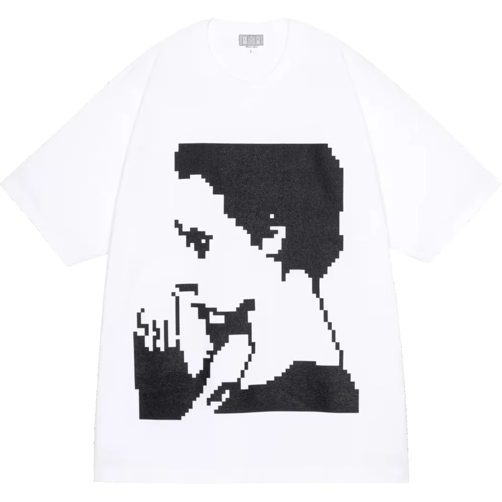 White T-shirt with a large black pixel-art portrait of a person holding a camera, displayed against a white background
