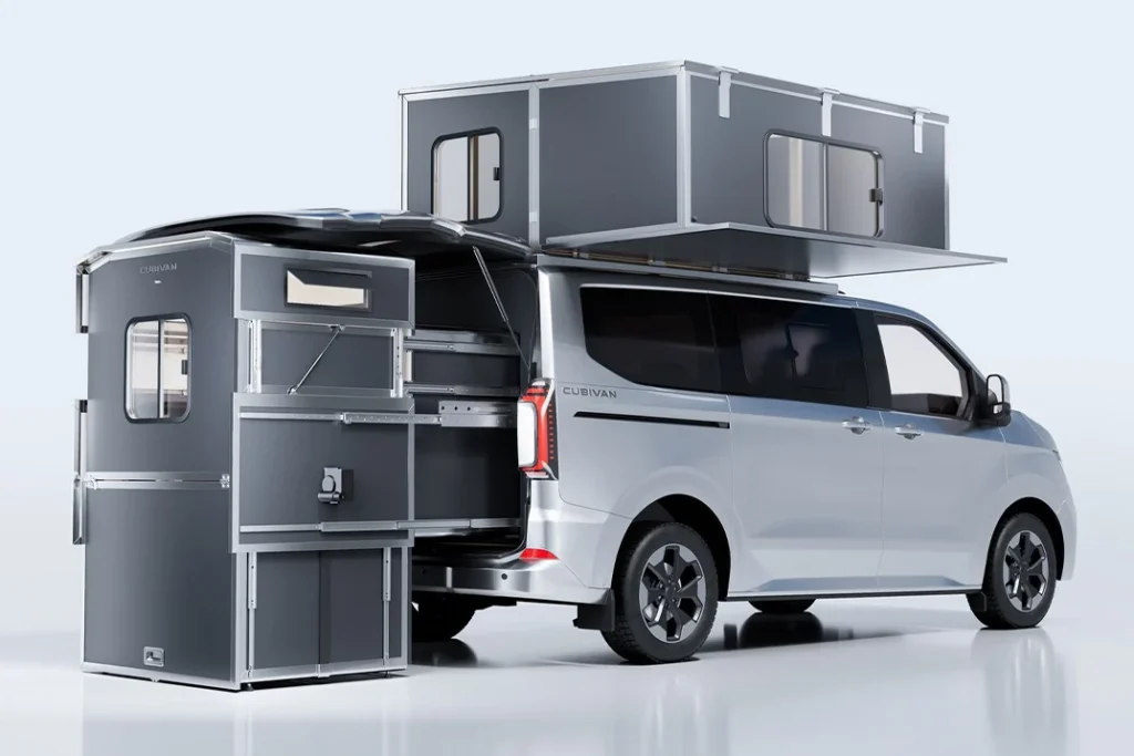 White Cubivan minivan with a gray modular camper room extended from the rear and a rooftop sleeping compartment