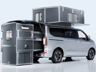 White Cubivan minivan with a gray modular camper room extended from the rear and a rooftop sleeping compartment