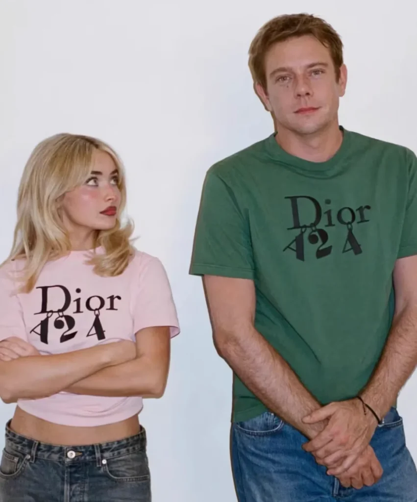 Sabrina Carpenter in a pink Dior Tee stands with folded arms beside Jonathan Andersonm in a green Dior Tee against a white background