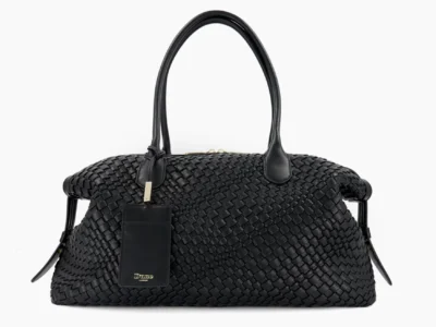 Black woven leather duffel bag with two handles and a hanging rectangular tag, centered against a white background