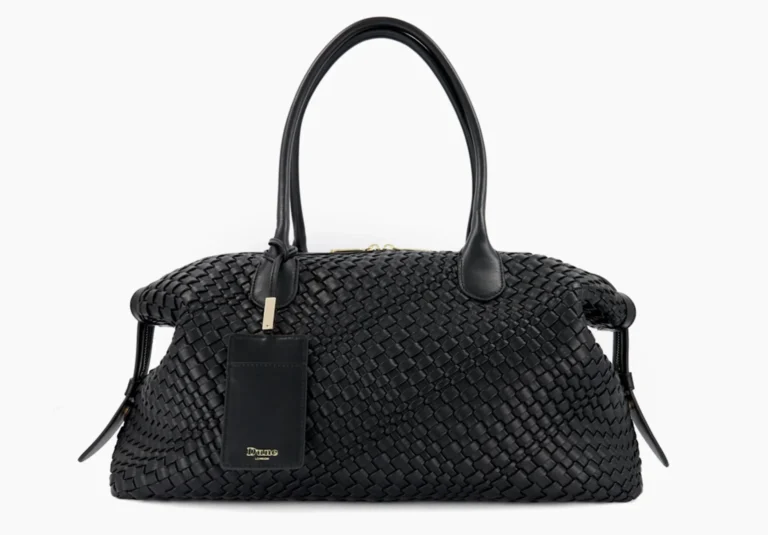 Black woven leather duffel bag with two handles and a hanging rectangular tag, centered against a white background