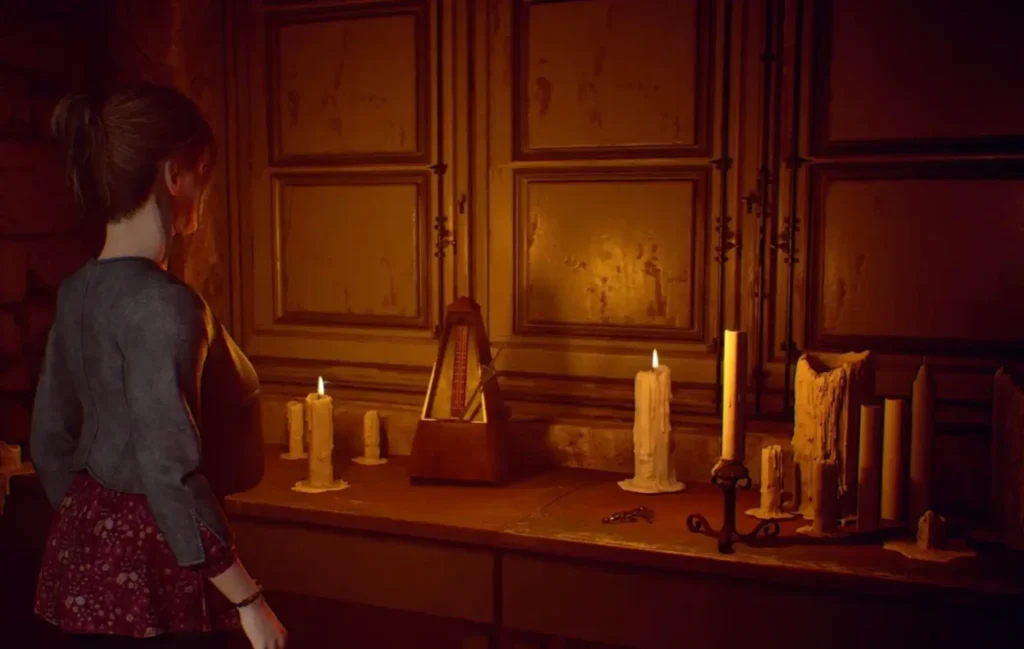Woman in a gray cardigan faces an altar-like table crowded with lit candles in a dim wooden room