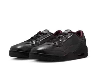 Pair of black Air Jordan shoe with burgundy lining, angle side by side on a white background