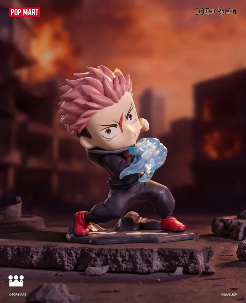 Chibi figure with pink spiky hair, black outfit and red shoes, posed holding a translucent blue energy effect on rocky ground