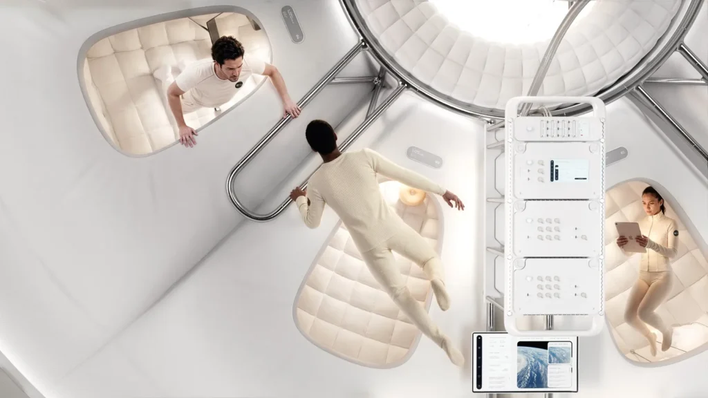 Three people in cream clothing move through a futuristic white capsule interior with padded pods, railings and control panels