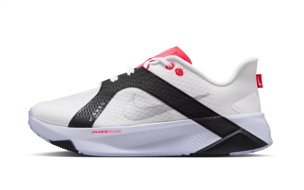White Nike shoe with black textured straps, red accents, and a sculpted white sole on a white background