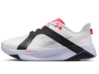 White Nike shoe with black textured straps, red accents, and a sculpted white sole on a white background