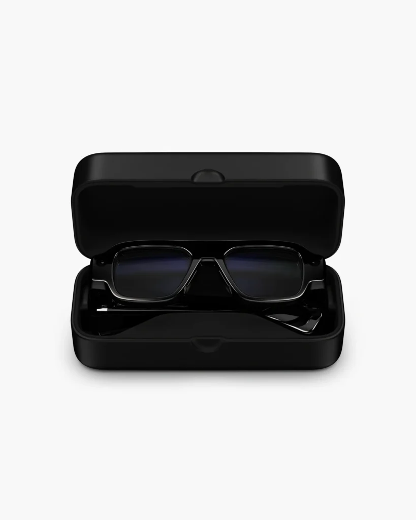 Black rectangular sunglasses resting in an open black hard case on a white background