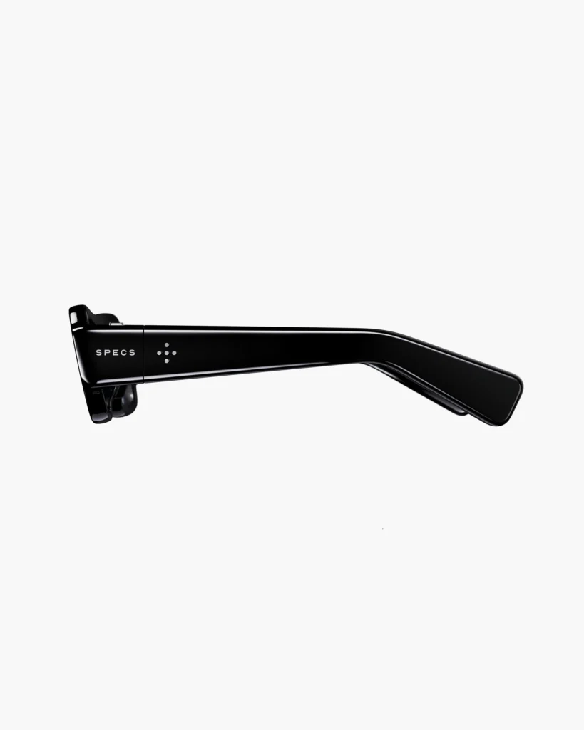 Side profile of glossy black glasses with a thick temple, silver dot details, and “SPECS” text on a white background