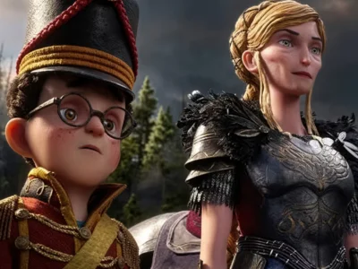 Two stop-motion characters stand outdoors: a bespectacled boy in a tall hat and a blonde woman in black feathered armor