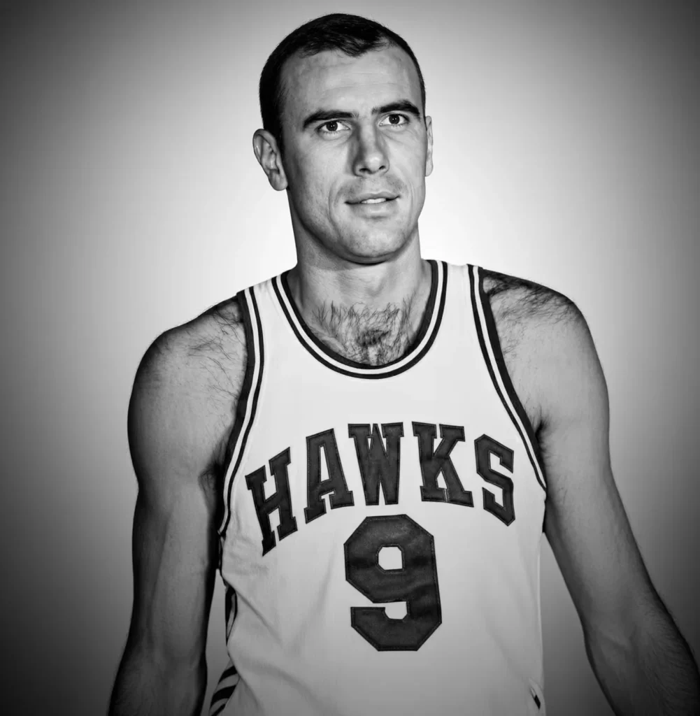 Black-and-white portrait of Bob Pettit wearing a Hawks basketball jersey with number 9 against a plain background