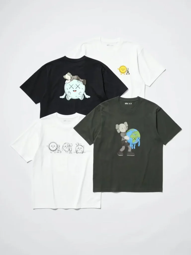 Four graphic T-shirts arranged on a white background, featuring KAWS character illustrations in black, white and dark gray