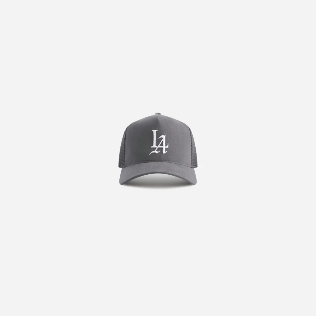 Charcoal brushed-twill trucker cap with black mesh sides and white LA logo, centered on a light gray background