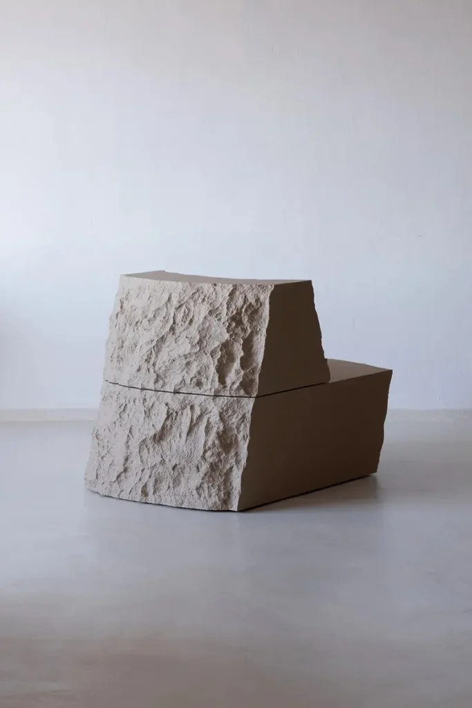 Lapis Lounge Chair by Pablo Octavio with rough torn-foam surfaces and smooth brown side panels.