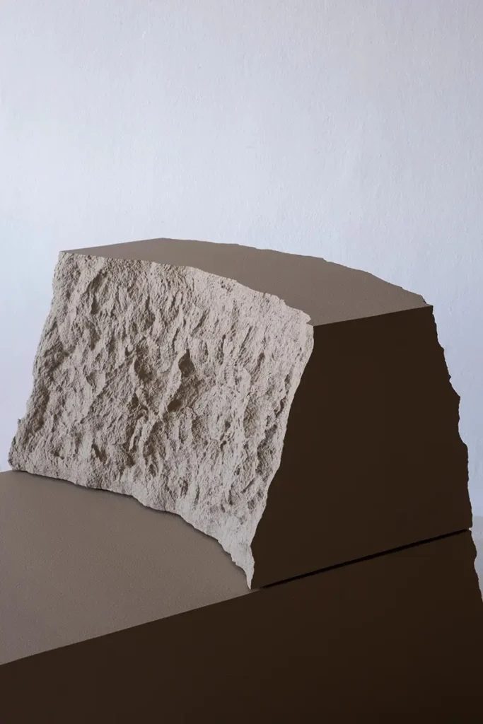 Close view of a Lapis Lounge Chair backrest with rough white texture and smooth brown side panels.