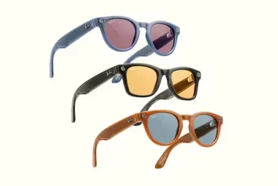 Three pairs of Ray-Ban Meta smart glasses in black, translucent gray, and brown with tinted lenses on a white background