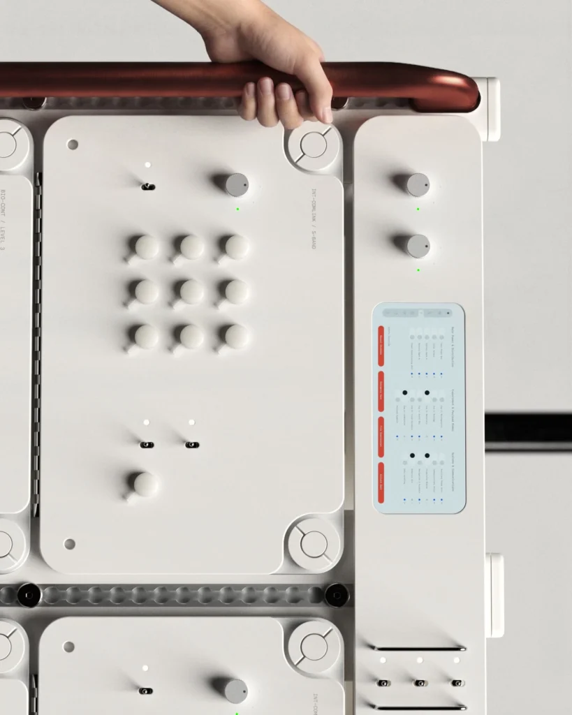 Top-down view of modular white audio equipment with knobs, switches, a small display, and a hand gripping a red handle
