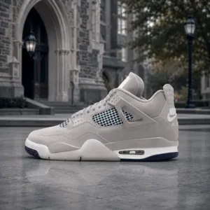 Pewter gray high-top sneaker with mesh panels and navy outsole on wet pavement before a stone building