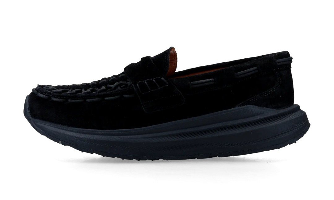 Black suede loafer with braided vamp, raised tongue, padded collar, and thick black sole against a white background