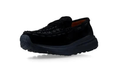 Black suede loafer with braided detailing and a thick lugged sole, shown against a white background