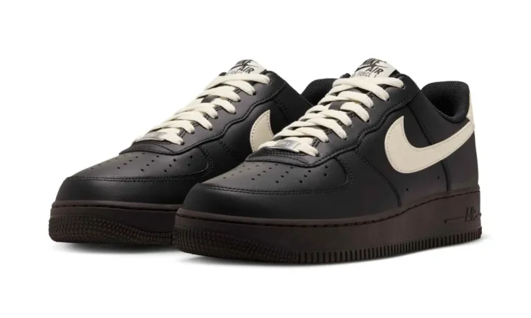 Pair of black Nike Air Force 1 sneakers with cream swooshes and laces on a white background