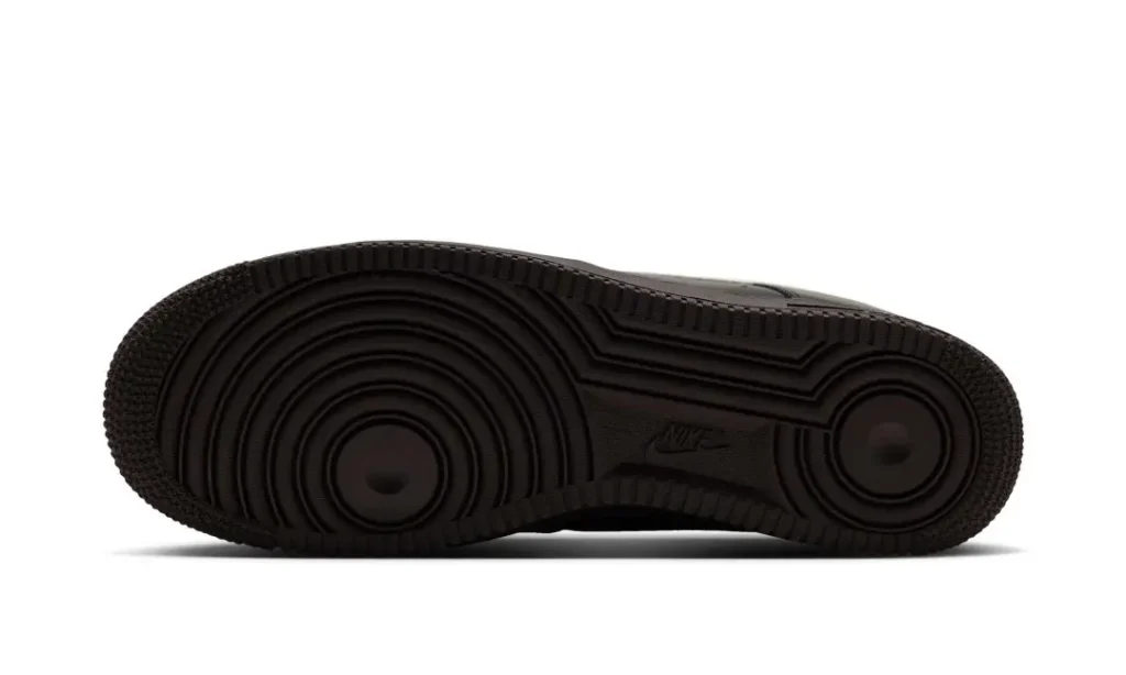 Black Nike sneaker outsole with concentric circular tread patterns, shown in profile against a white background