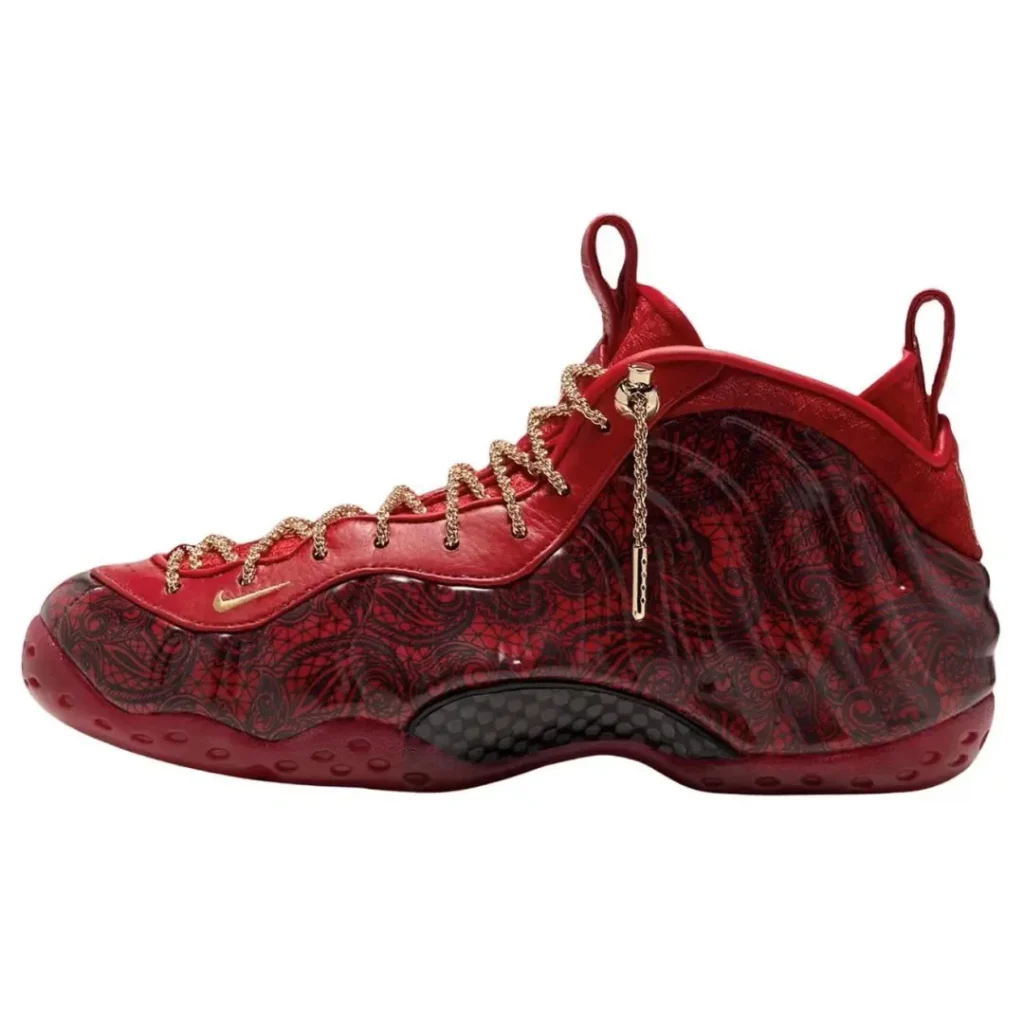 Red high-top sneaker with gold chain laces, patterned dark-red upper, and black textured sole detail on white background