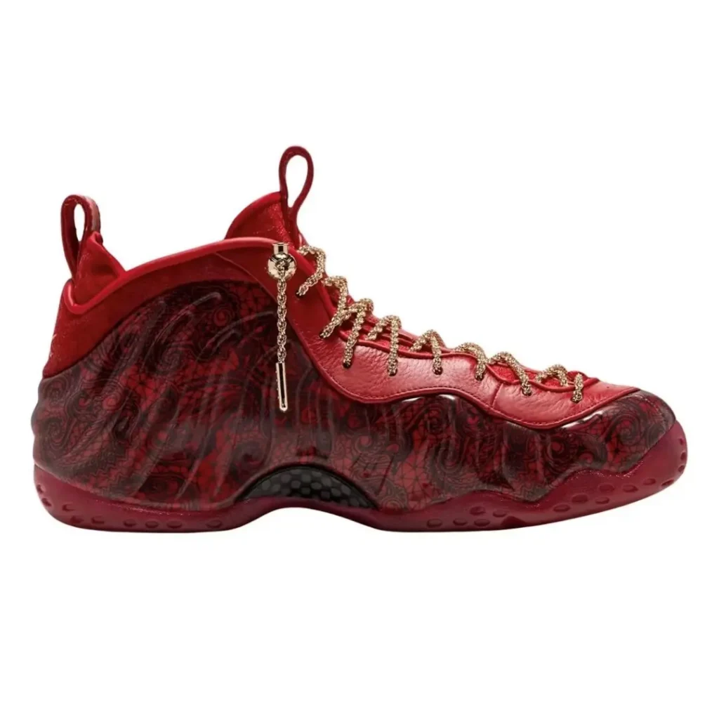 Red high-top sneaker with paisley-patterned translucent panels, gold rope laces and side zipper on white background