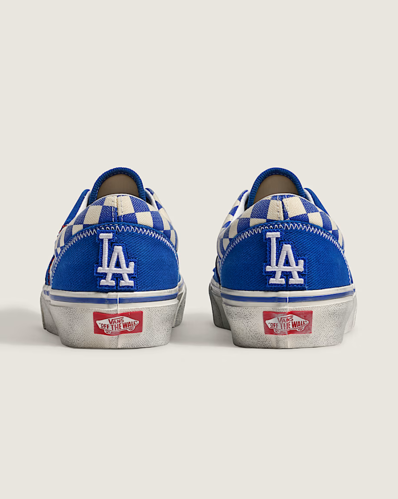 Rear view of two blue-and-white Vans sneakers with Los Angeles Dodgers logos and checkered panels