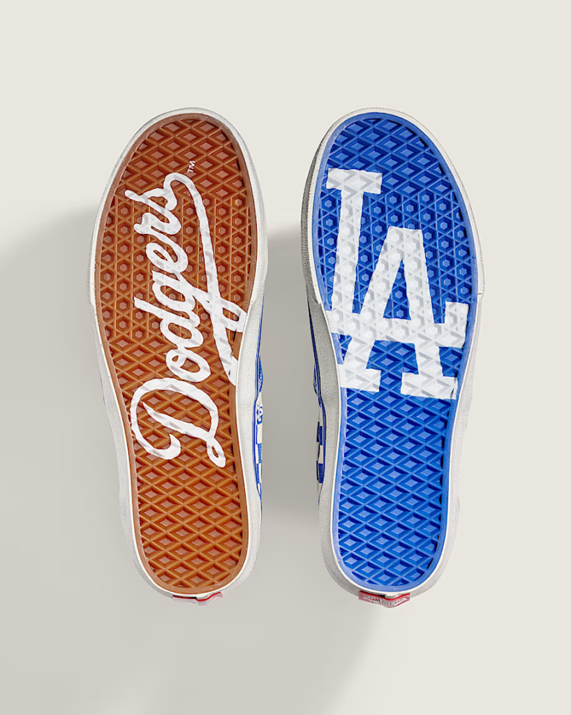 Two Vans shoe soles, one red with white script and one blue with white lettering, displayed side by side