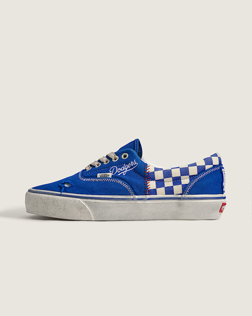 Blue Vans sneaker with white checkerboard panels, Dodgers script, and a textured off-white sole