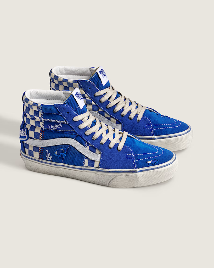 Blue-and-white checkered Vans high-top sneakers with Los Angeles Dodgers details on a light background