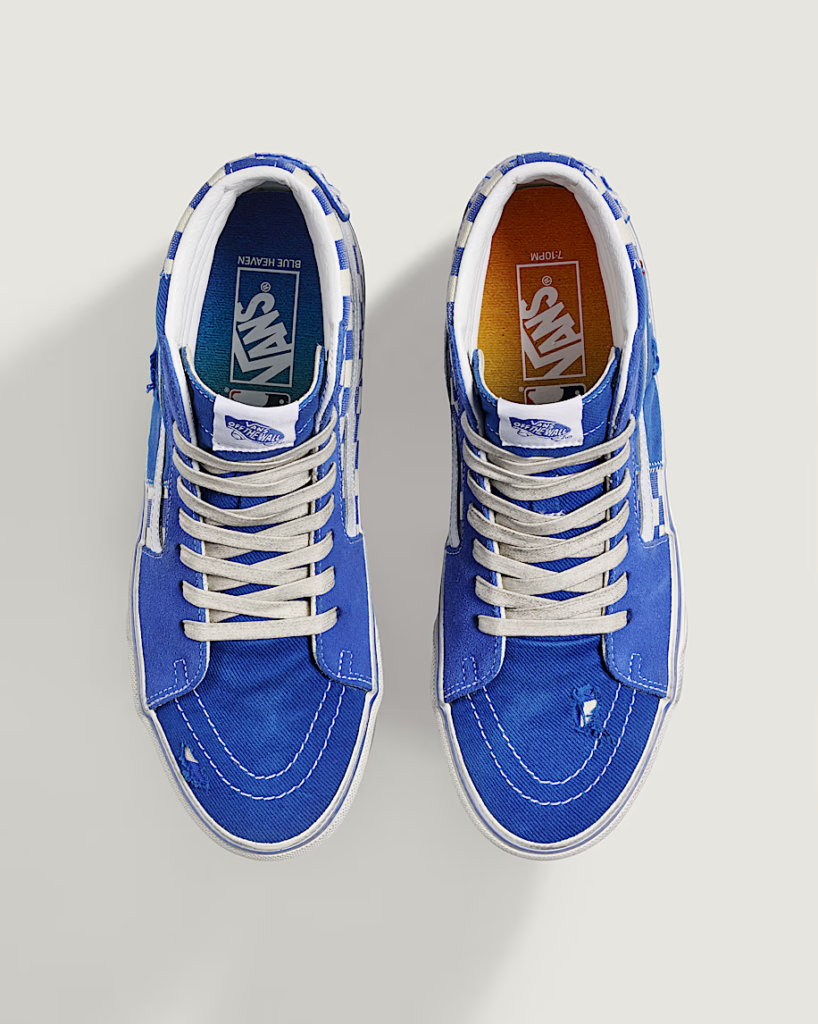 Top-down view of two blue-and-white Vans sneakers with contrasting insoles and laces on a light background
