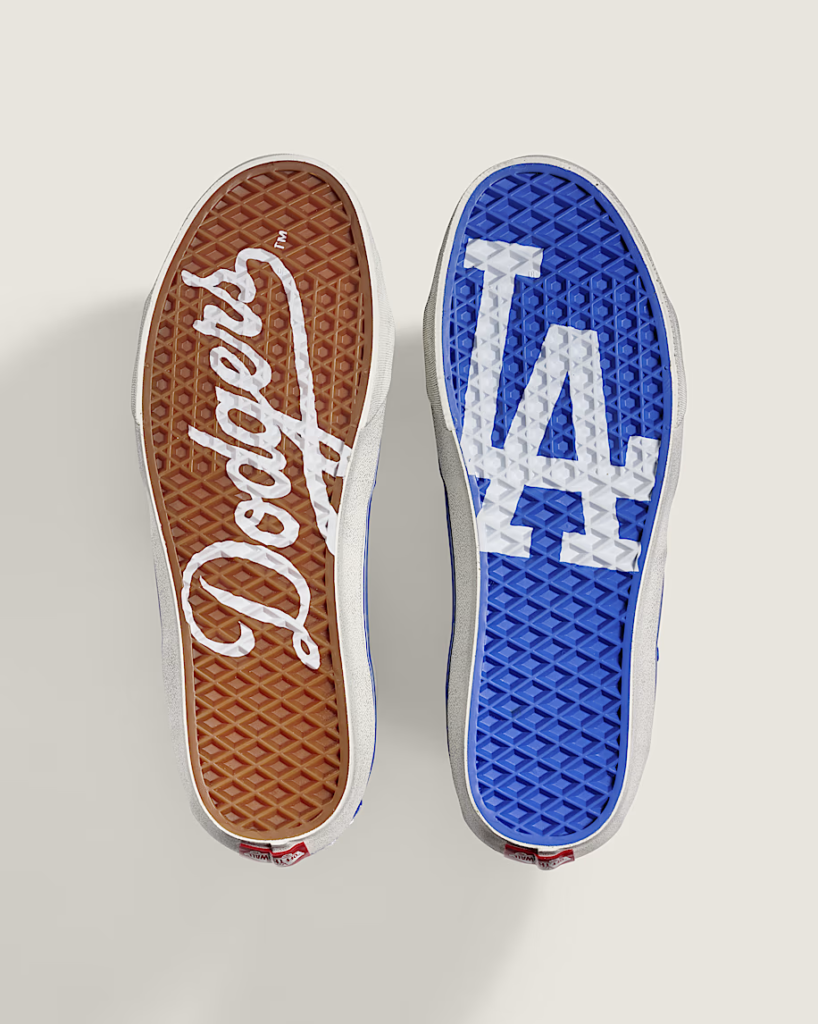 Two Vans shoe soles, one brown with white script and one blue with a white LA logo, shown side by side