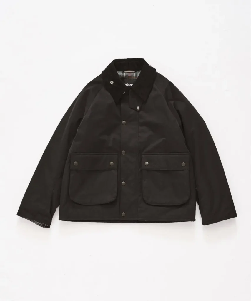 Black waxed cotton jacket with a corduroy collar, snap closures and two large flap pockets on white background