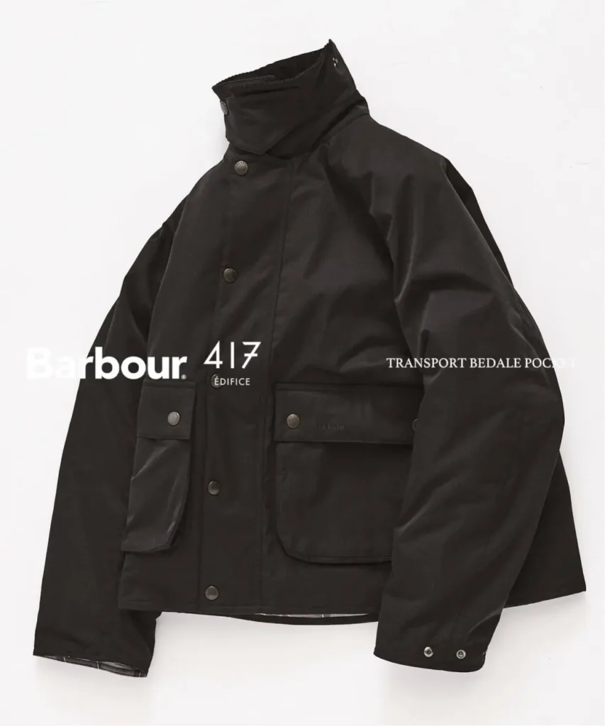 Black Barbour jacket with high collar, snap closures, and two large flap pockets against a white background