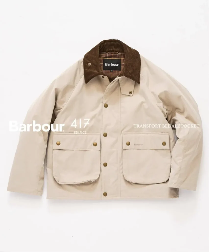 Cream Barbour jacket with brown corduroy collar, plaid lining and two large flap pockets, displayed against white background