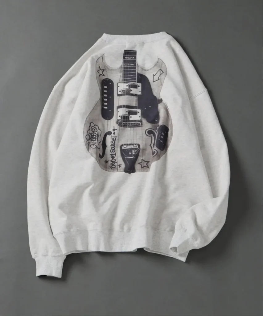 White sweatshirt with a black-and-gray electric guitar graphic and doodles, laid flat on a gray background