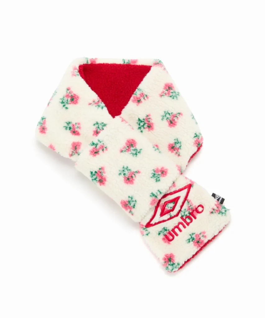 Cream fluffy scarf with pink and green floral print, red triangular accent, and Umbro logo on white background