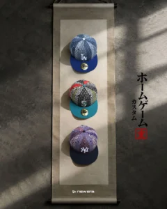 Three pattern baseball caps with blue, teal and black brims displayed vertically on a hanging scroll-style panel beside