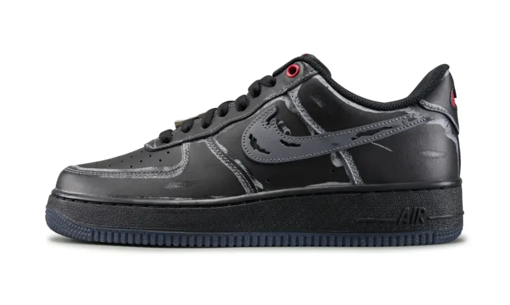 Black low-top sneaker with a tonal swoosh, red eyelet, black sole, and textured rubber outsole on a white background