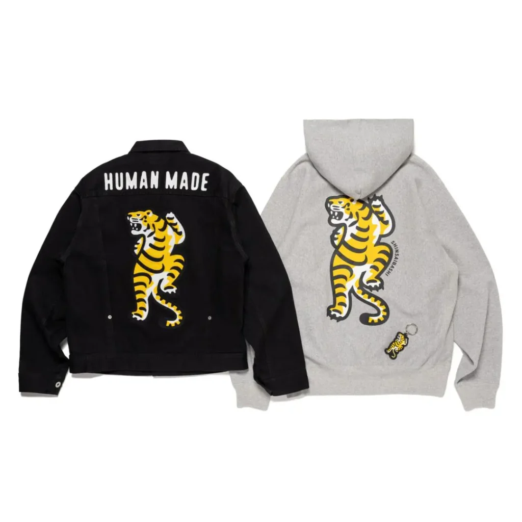 Black jacket and gray hoodie featuring matching yellow tiger graphics; jacket reads “HUMAN MADE”