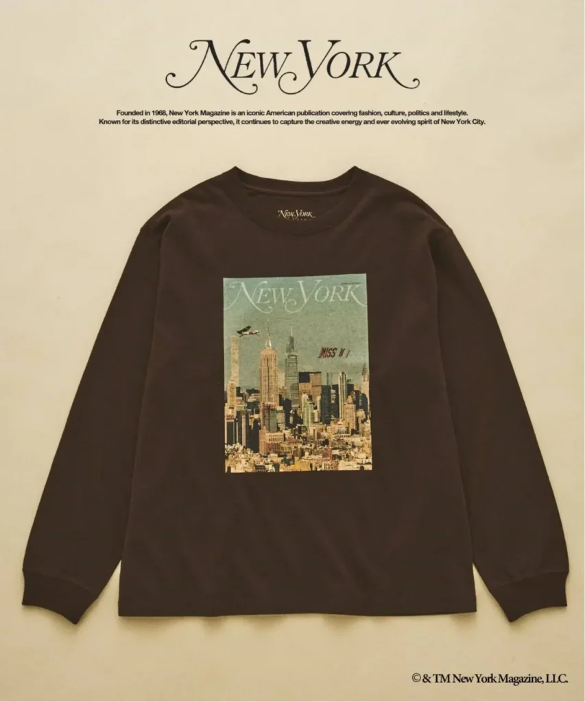 Dark brown long-sleeve shirt laid flat, featuring a New York skyline graphic on the chest