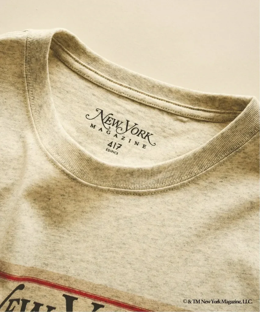 Close-up of a beige T-shirt collar with “New York Magazine” and “Magazine” printed inside