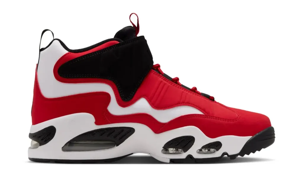 Red, white and black high-top athletic shoe with a thick sculpted sole and red laces against a white background